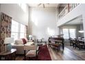 Spacious living room featuring tall ceilings, large windows, and a grand piano at 3468 Glen Abbe Ct, Carmel, IN 46032