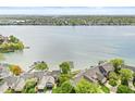 Scenic aerial view of lakefront homes, docks and lush trees in a serene waterside community at 3539 Clearwater Cir, Indianapolis, IN 46240