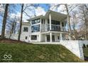 Beautiful modern home with a white exterior, black framed windows, and lush green yard at 395 Breakwater Dr, Fishers, IN 46037