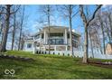 Stunning modern home features large windows, white exterior, and meticulously landscaped grounds at 395 Breakwater Dr, Fishers, IN 46037