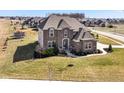 Beautifully landscaped corner lot home with a spacious lawn, playground, and sidewalks at 4255 Kettering Dr, Zionsville, IN 46077