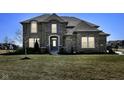 Inviting two-story home with a well-maintained lawn and traditional brick facade at 4255 Kettering Dr, Zionsville, IN 46077