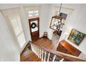 Bright foyer with hardwood floors, stairs, and decorative light fixture creates a grand entry at 450 W Ash St, Zionsville, IN 46077