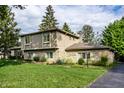 Beautiful home with stone accents, a chimney, and a well-manicured lawn at 4528 Brookshire Pkwy, Carmel, IN 46033