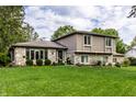 Charming house with a large yard, stone and siding details, and plenty of curb appeal at 4528 Brookshire Pkwy, Carmel, IN 46033