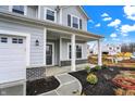 Inviting front porch with stylish columns, dark front door, and manicured landscaping at 5777 Greenbrier Ct, Brownsburg, IN 46112