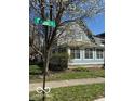Corner lot home with light blue siding, white trim, and mature landscaping at 590 W Cedar St, Zionsville, IN 46077