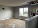 Damaged living room with exposed wall, damaged floors, and water stained walls at 6009 Tammin Dr, Indianapolis, IN 46254
