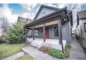 Charming home featuring a welcoming front porch and nicely landscaped yard at 615 E Morris St, Indianapolis, IN 46203