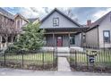 Charming home featuring a welcoming front porch and nicely landscaped yard at 615 E Morris St, Indianapolis, IN 46203