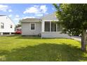 Well-maintained backyard with a lush green lawn and charming exterior features at 633 Fletcher Ln, Beech Grove, IN 46107