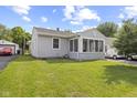Charming home with a screened-in porch and a well-maintained green lawn at 633 Fletcher Ln, Beech Grove, IN 46107