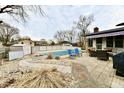 An inviting backyard area has a large in-ground pool, a patio area, and plenty of space for lounging at 695 Valley Oaks Rd, Greenwood, IN 46143