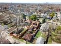 Aerial view of a neighborhood with cozy homes and tree-lined streets and a distant skyline at 741 Dequincy St, Indianapolis, IN 46201