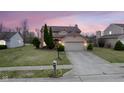Charming two-story home with attached two-car garage and well-manicured landscaping at 7531 Bancaster Dr, Indianapolis, IN 46268