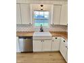 Bright kitchen featuring white cabinets, subway tile backsplash, butcher block counters and a farmhouse sink at 7874 E County Road 200 N, Avon, IN 46123