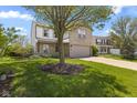 Charming two-story home featuring a brick facade, attached garage, and well-manicured lawn at 8551 Belle Union Ct, Camby, IN 46113