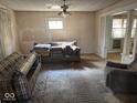 Living room featuring neutral walls, pillowed couch and vintage furnishings at 942 N Oxford St, Indianapolis, IN 46201