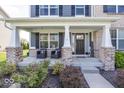 Inviting front porch with brick pillars and comfortable seating area at 10027 Landis Blvd, Fishers, IN 46040