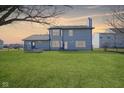 A well-maintained backyard with lush green grass and a charming blue two-story home at 10212 Ironway Dr, Indianapolis, IN 46239