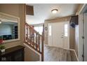 Welcoming foyer with wood flooring, stairs, and a view into the dining room at 10212 Ironway Dr, Indianapolis, IN 46239