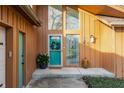 Inviting front entrance with a teal door, accented by a wreath, plants, and sidelight windows at 10373 Briar Creek Pl, Carmel, IN 46033