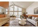 Bright living room with vaulted ceilings, large windows, and modern furnishings with hardwood floors at 10373 Briar Creek Pl, Carmel, IN 46033