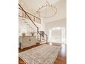 Grand foyer with a chandelier, wood floors, curved staircase, and bright natural light at 1098 Laurelwood, Carmel, IN 46032