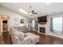 Spacious living room with fireplace, vaulted ceilings, skylight, fan, and hardwood floors at 12929 Shandon Ln, Fishers, IN 46038