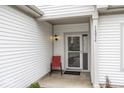 Inviting front porch with a chair adjacent to the door with house number listed on the trim at 14014 Keams Dr, Fishers, IN 46038