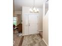 Bright entryway featuring carpet flooring, a white front door, and stairs leading to the upper level at 14014 Keams Dr, Fishers, IN 46038