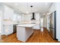 Modern kitchen featuring white cabinetry, stainless steel appliances, and hardwood floors at 14339 Jeremy Dr, Carmel, IN 46033