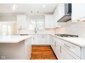Close-up of a modern kitchen with white cabinets, an island, and hardwood floors at 14339 Jeremy Dr, Carmel, IN 46033