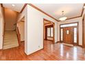 Inviting entryway features hardwood floors and staircase, creating a warm welcome at 14365 Laura Vista Dr, Carmel, IN 46033