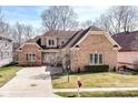 Charming brick home with well-maintained lawn and landscaping and inviting curb appeal at 14365 Laura Vista Dr, Carmel, IN 46033