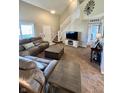 Comfortable living room with a large sectional sofa and view of the staircase and entry door at 1905 Collingwood Dr, Avon, IN 46123