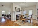 Cozy dining room featuring a fireplace, modern lighting, and hardwood flooring at 2037 Rhettsbury St, Carmel, IN 46032