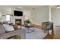 Spacious living room with a fireplace, comfortable seating, and hardwood floors at 2037 Rhettsbury St, Carmel, IN 46032