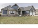 Charming single-Gathering home showcasing a well-manicured lawn, blue siding and brick accents, offering delightful curb appeal at 2145 W Bedrock Ln, Greenfield, IN 46140