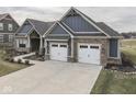Exterior shot of a home with a spacious three-car garage and a well-manicured front yard at 2145 W Bedrock Ln, Greenfield, IN 46140