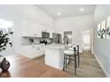 Kitchen featuring white cabinets, stainless steel appliances, and a marble-look countertop at 242 N Tacoma Ave, Indianapolis, IN 46201