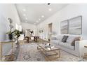 Bright living room featuring light wood floors, white walls, and a white sofa at 242 N Tacoma Ave, Indianapolis, IN 46201