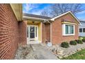 Inviting front entrance with a decorative door and a welcoming sign nestled in the landscaping at 2618 Inlet Dr, Cicero, IN 46034