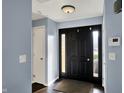 Entryway featuring a dark wood floor and doors, light blue walls, and a flush mount ceiling light at 2618 Inlet Dr, Cicero, IN 46034
