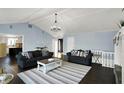 Spacious living room with vaulted ceilings, a fireplace, dark hardwood floors, and neutral furniture at 2618 Inlet Dr, Cicero, IN 46034