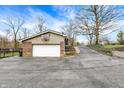 Spacious garage with basketball hoop and a long paved driveway at 381 Redbud Pl, Greenwood, IN 46142