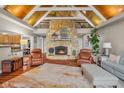 Inviting living room with vaulted wood ceilings and a floor-to-ceiling stone fireplace at 3849 Waycross Dr, Columbus, IN 47203