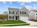Charming two-story home featuring gray siding, black shutters, a two-car garage, and a well-manicured lawn at 3913 Highcrest Rd, Indianapolis, IN 46239