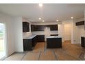 Spacious kitchen features dark cabinets, recessed lighting, and a center island perfect for entertaining at 3913 Highcrest Rd, Indianapolis, IN 46239