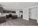 Modern kitchen featuring dark cabinetry, stainless steel appliances, an island, and sleek countertops at 3913 Highcrest Rd, Indianapolis, IN 46239